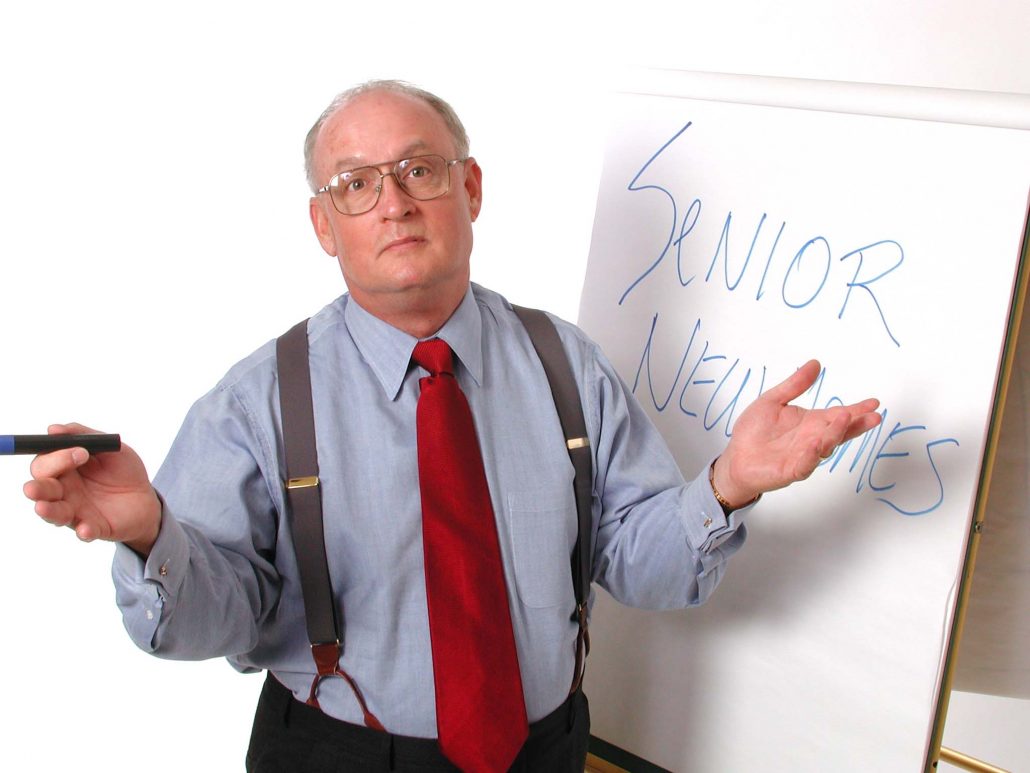 Michael Crosby, founder of The Real Estate Institute, teaching with a whiteboard.