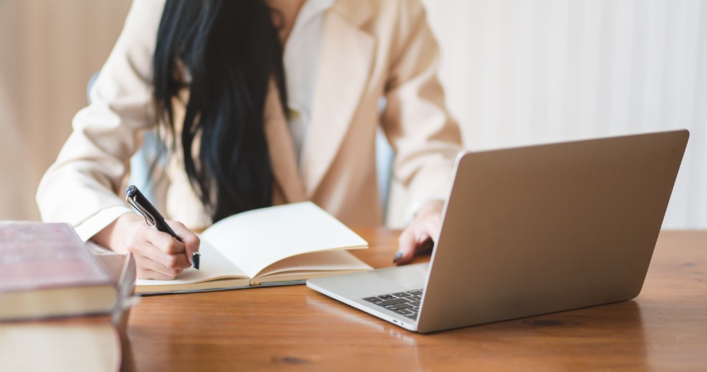 Female real estate agent working on a laptop 